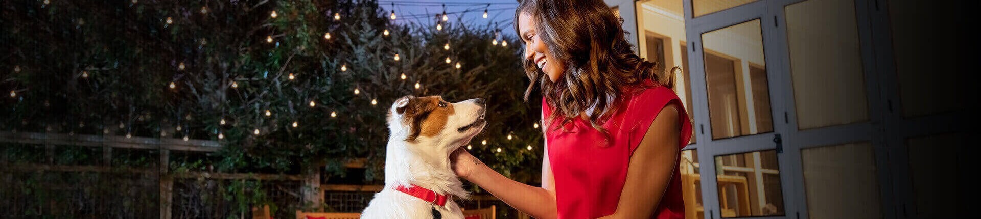 A woman pets her happy dog